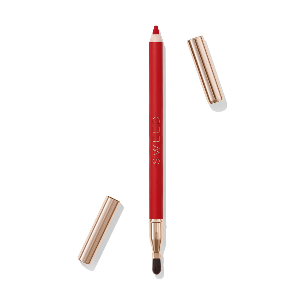 A red lip liner pencil with a gold cap, positioned between the pencil's body and its brush end.