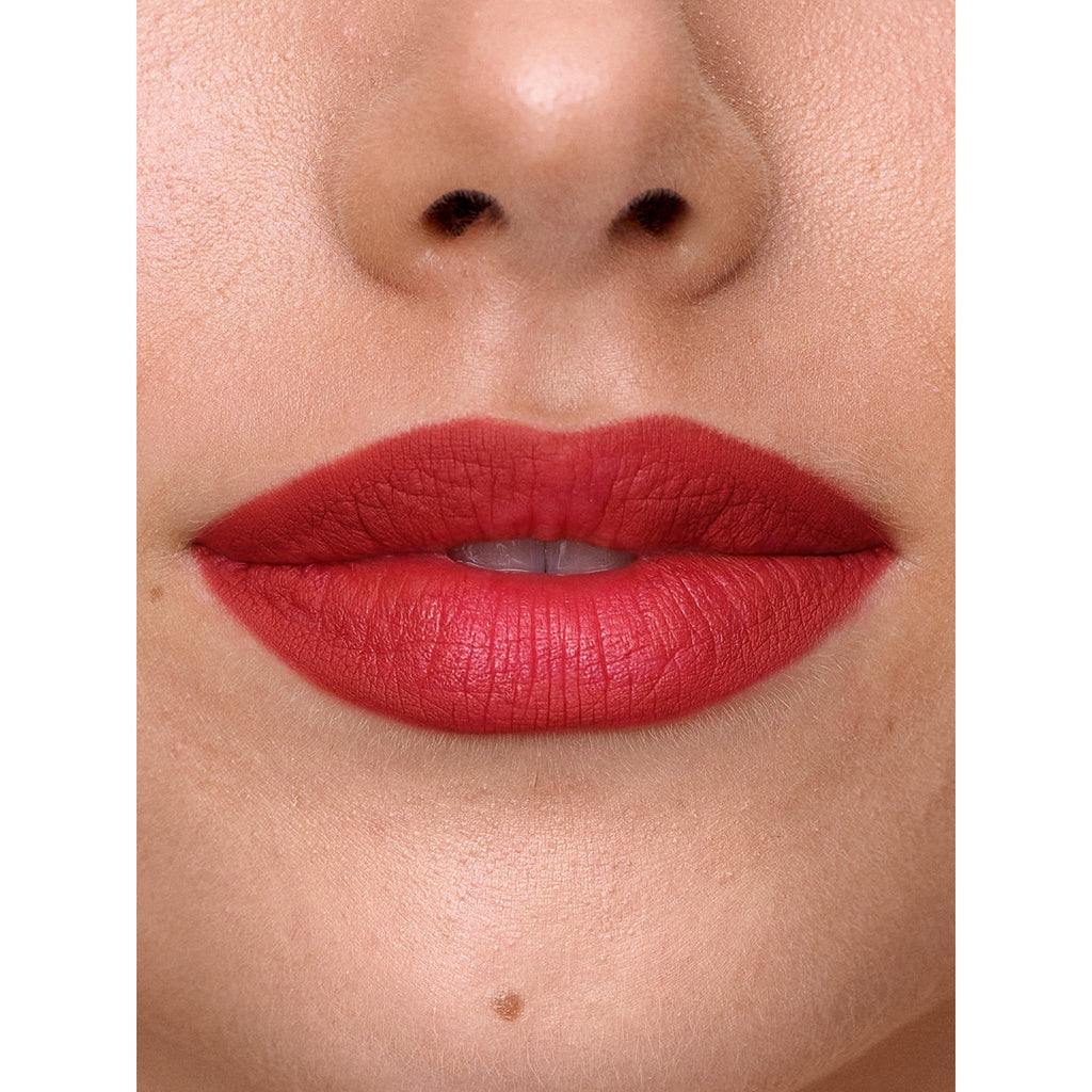 Close-up of a person's lips painted with red lipstick.