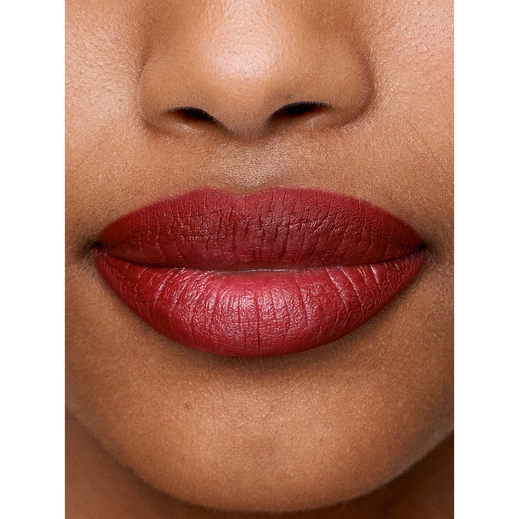 Close-up of a person's lips with red lipstick.