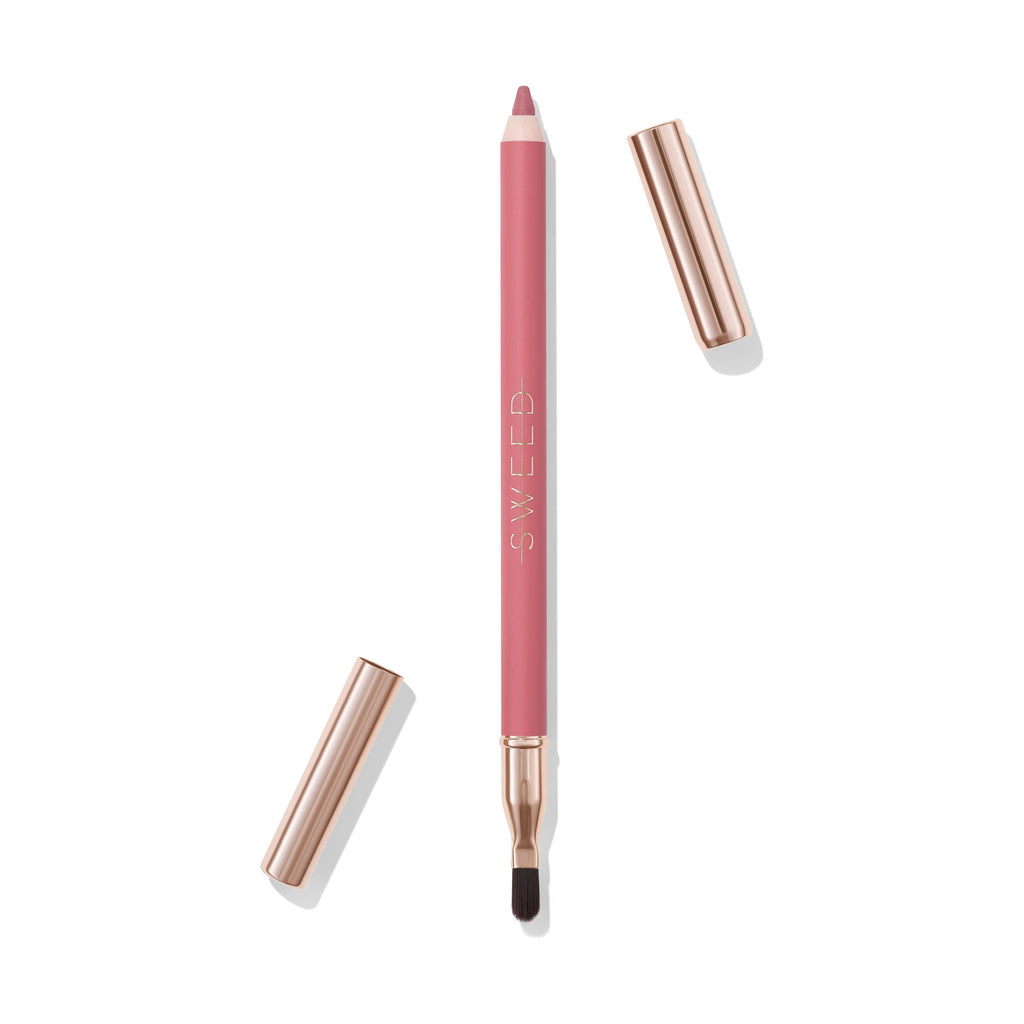 A lip liner pencil with cap removed, showing the tip and brush, isolated on a white background.