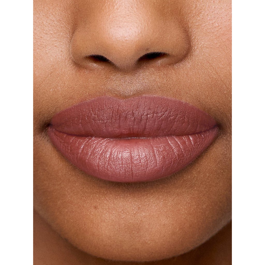 Close-up of a person's lips with burgundy lipstick.
