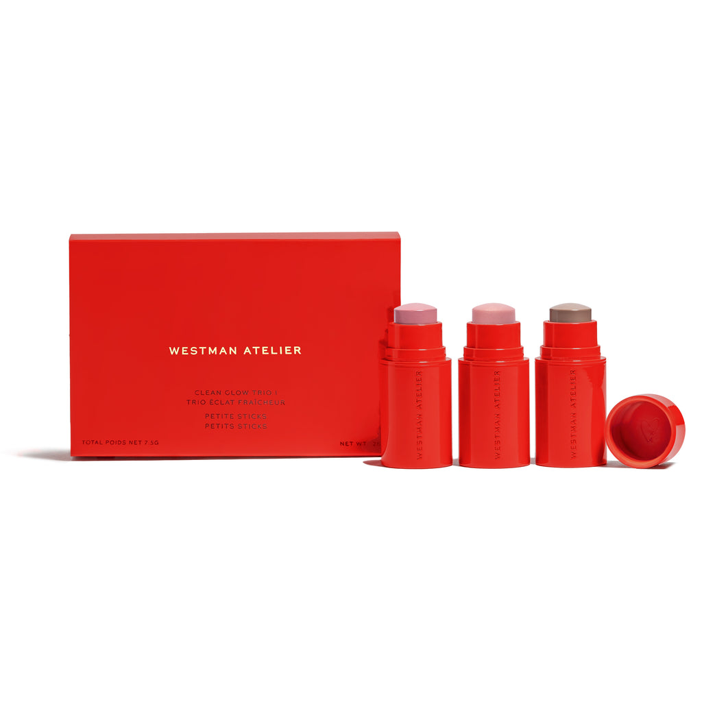 A set of four red twist-up cosmetic sticks with matching packaging displayed against a neutral background.
