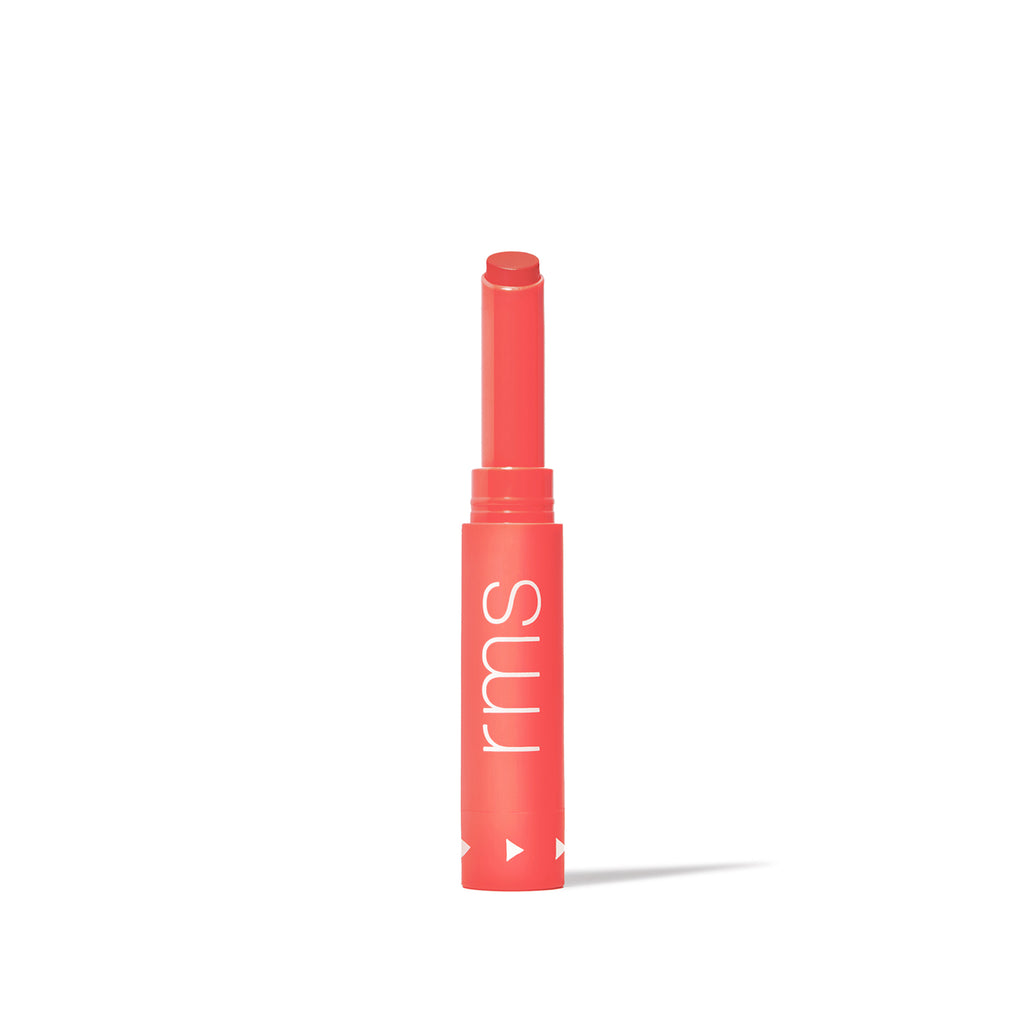 A single tube of coral lipstick with the lid off, isolated on a white background.