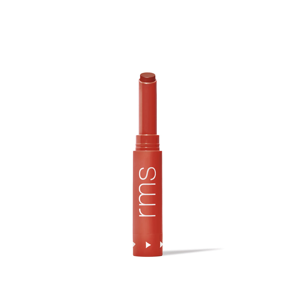 A single tube of red lipstick standing upright against a white background.