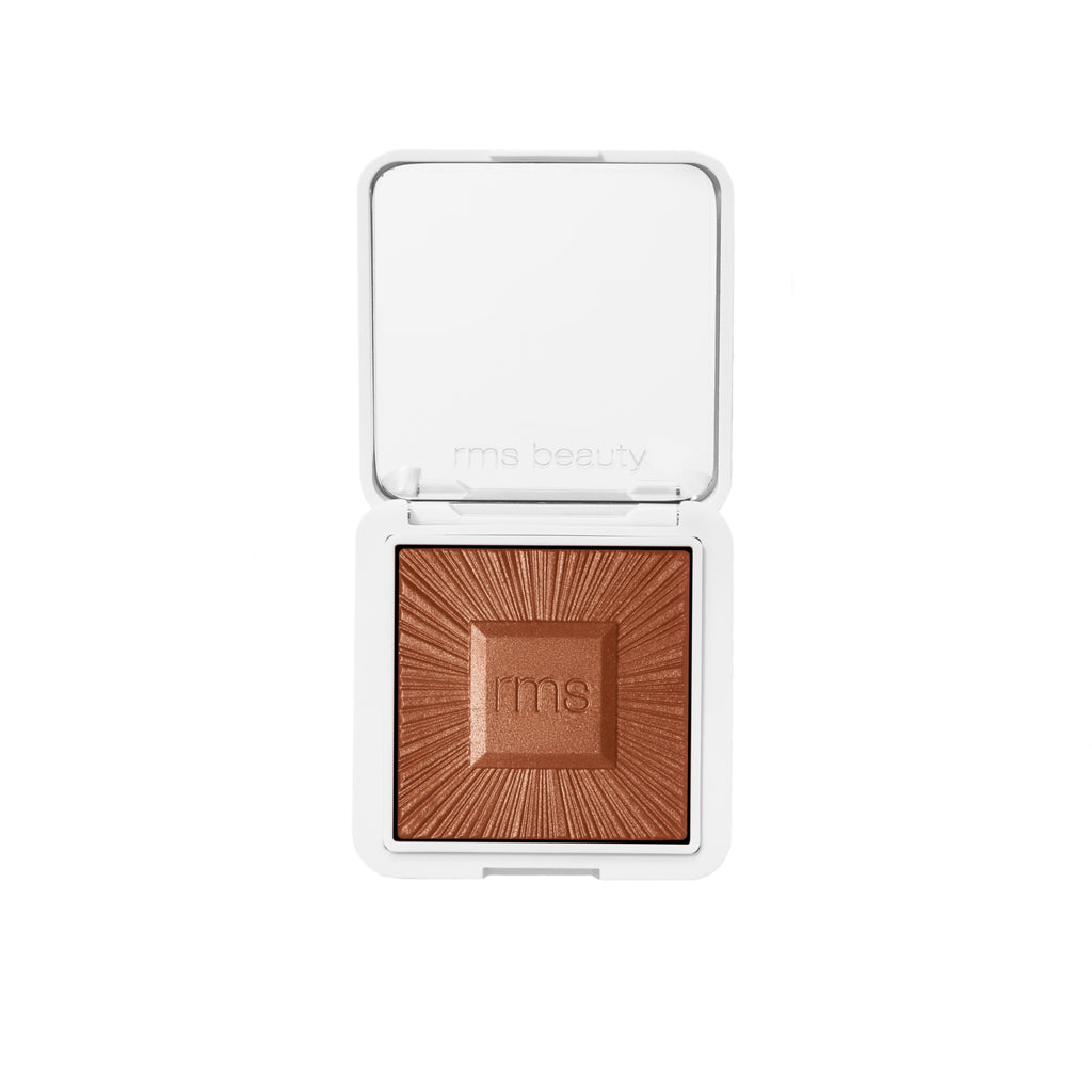 Compact pressed powder with logo embossed on the surface, showcased in an open white case.