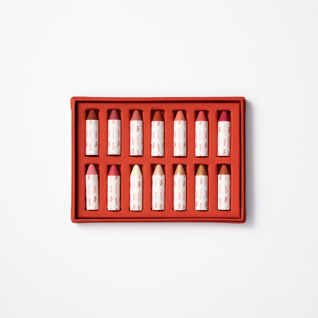 A box of neatly arranged red and white vials on a white background.