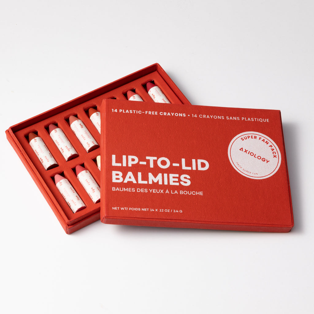 A set of 14 plastic-free lip balm crayons in a red box labeled "lip-to-lid balmies.