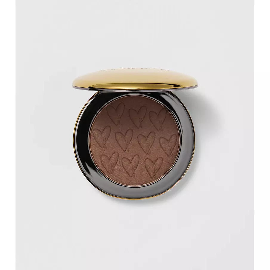 A compact powder with embossed hearts on its surface.