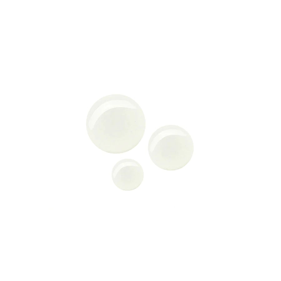 Three white pills of varying sizes on a white background.