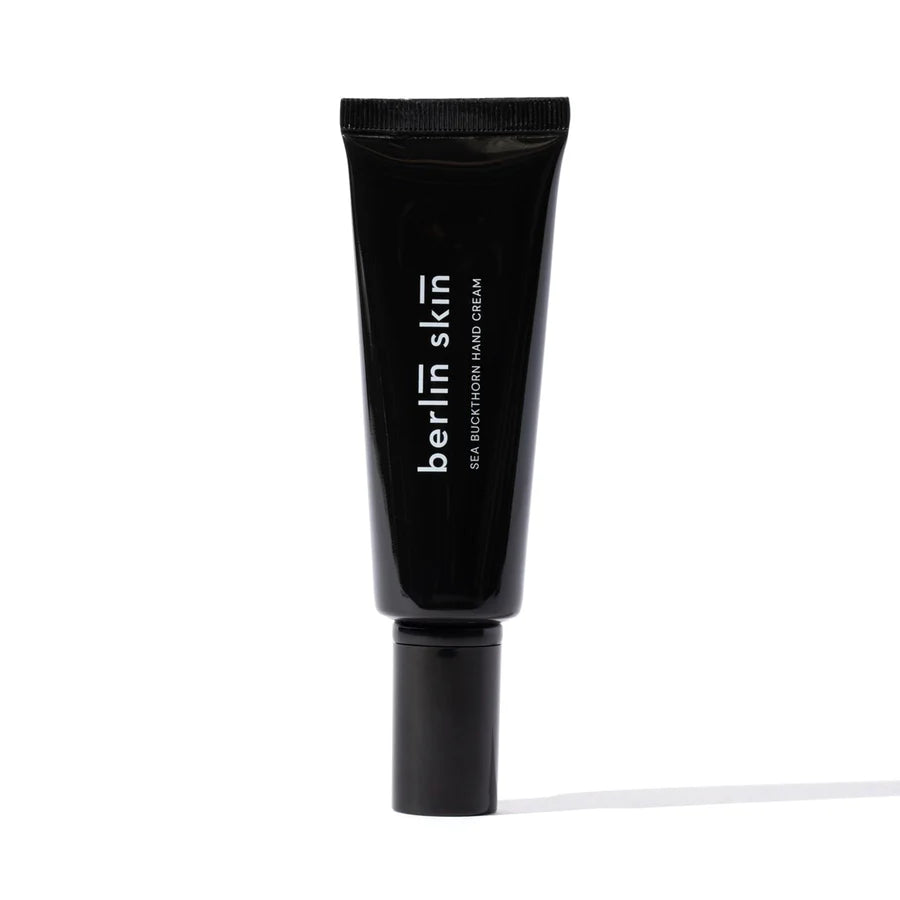 A black tube of "berlin skin" facial moisturizer against a white background.