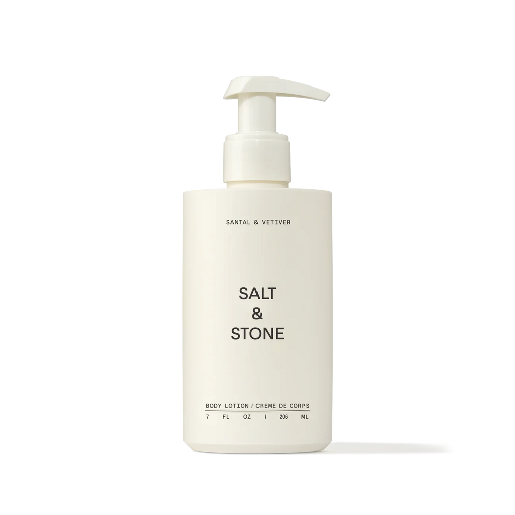 A pump bottle of salt & stone body lotion against a neutral background.