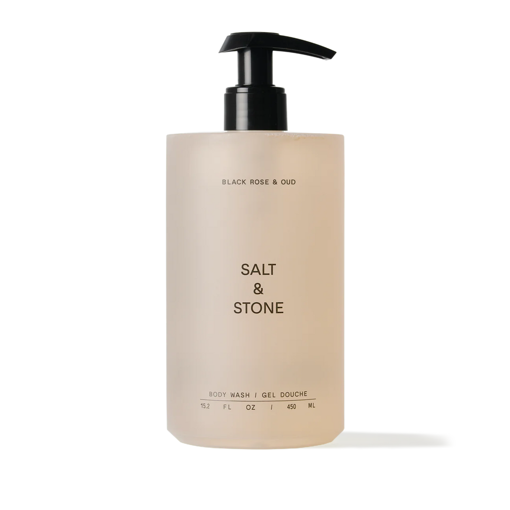 A pump bottle of salt & stone body wash with a beige label against a neutral background.