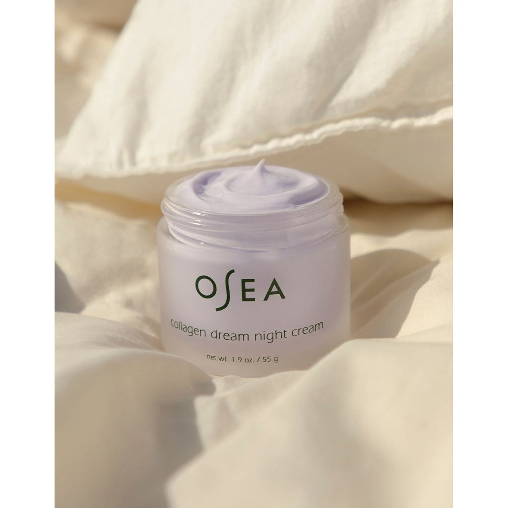 Jar of osea collagen dream night cream on a textured beige background.