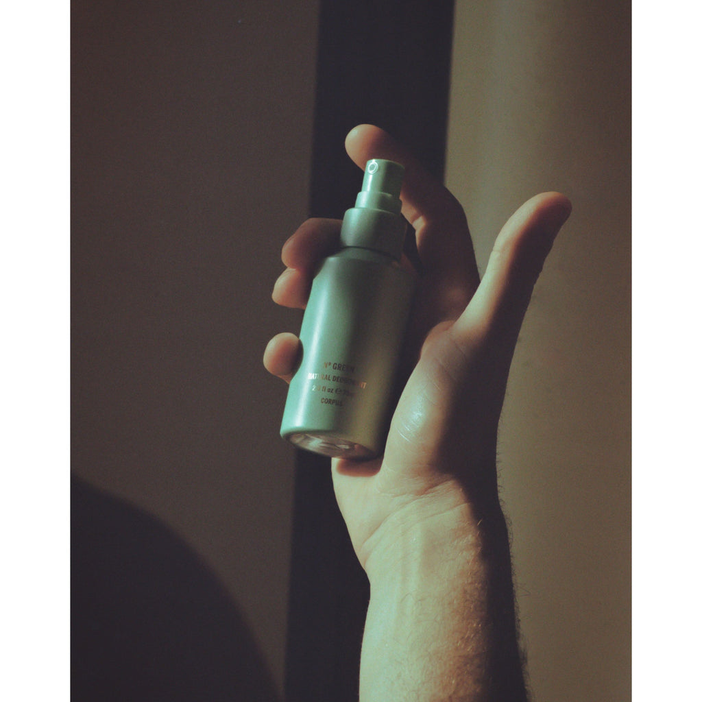 Hand holding deodorant spray