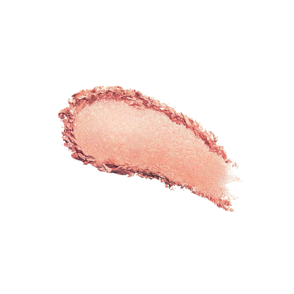 A swatch of shimmering bronze eyeshadow on a white background.