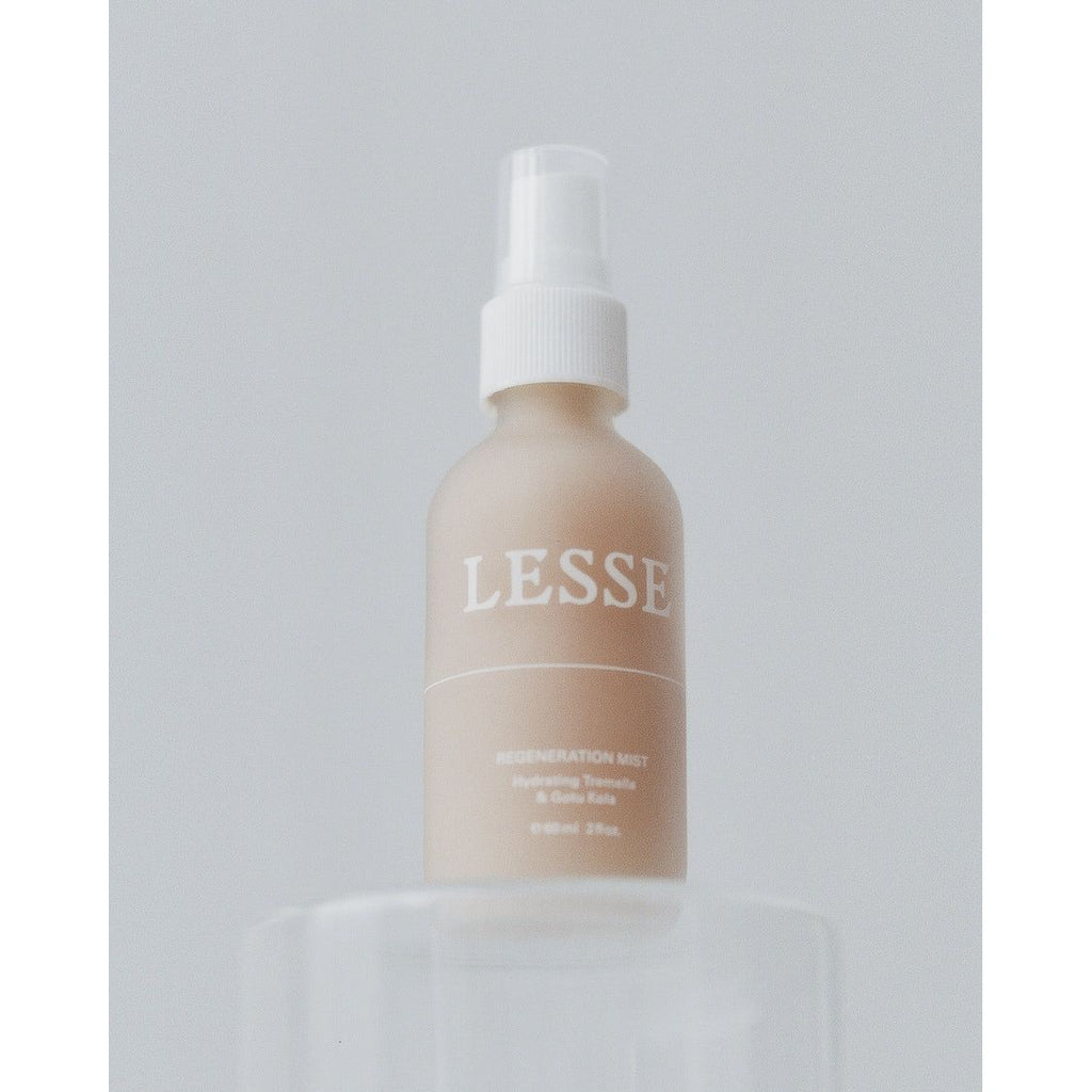 A bottle of lesse regeneration mist is positioned against a plain background.