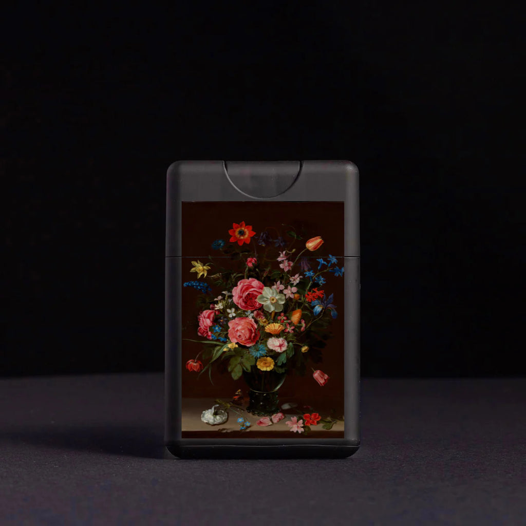 A portable phone with a floral design on its case, against a dark background.