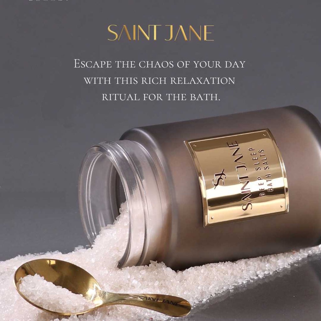 Luxury bath salts and a golden spoon presented on a mound of crystals for a soothing bathing experience.