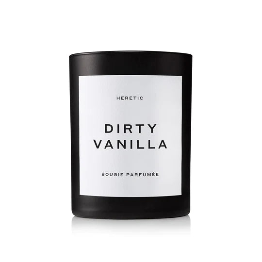 Black candle with "dirty vanilla" label by heretic.