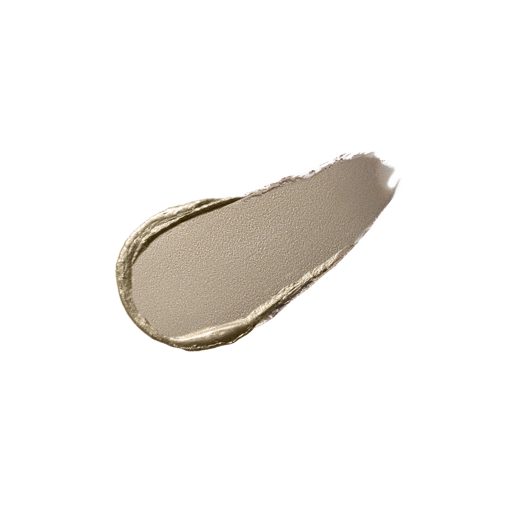 A smear of gold-toned cosmetic product against a white background.