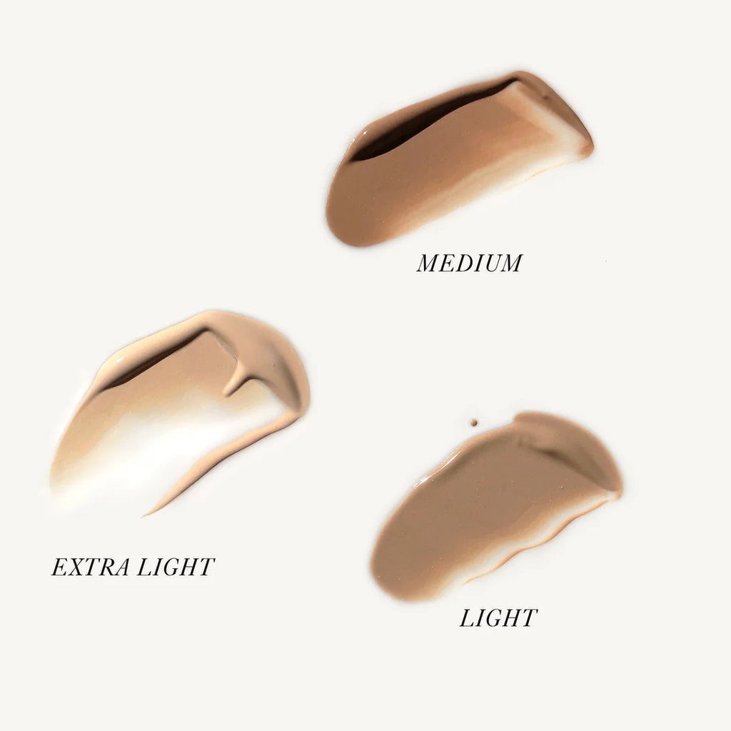 Different shades of foundation makeup swatches labeled extra light, light, and medium.