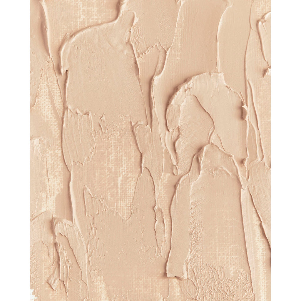 Close-up of textured beige foundation makeup smeared on a surface.