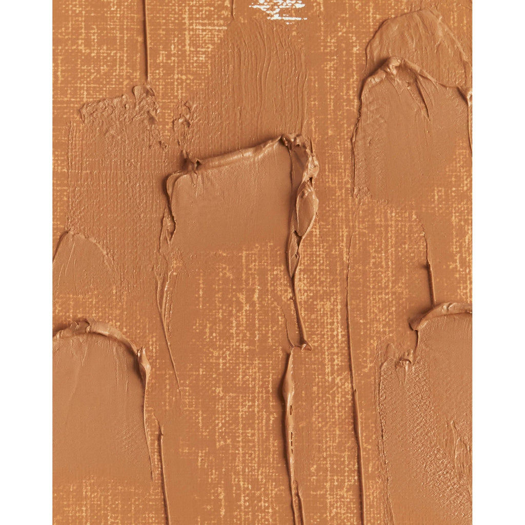 Close-up of textured beige makeup foundation smeared on a surface.