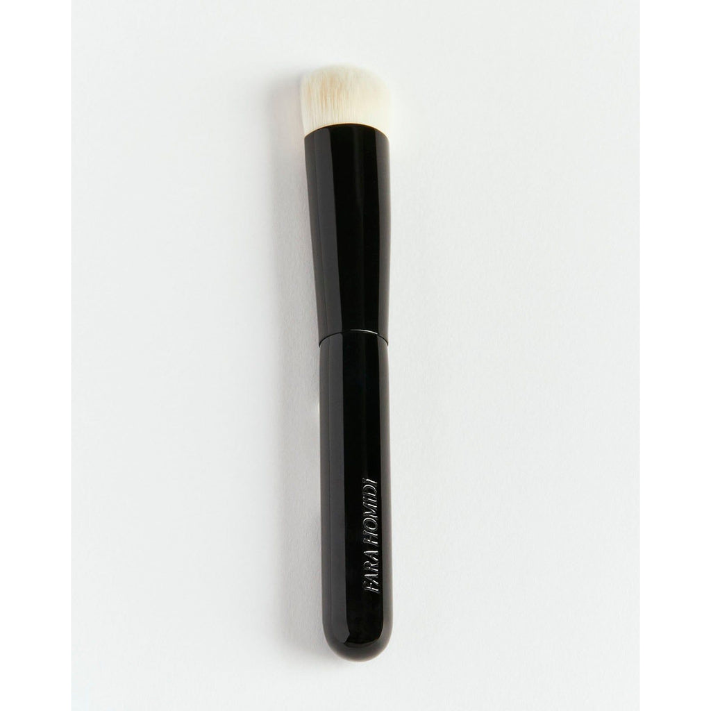 A single makeup brush with a black handle and white bristles, isolated on a white background.