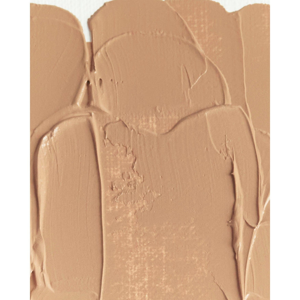 Close-up of a textured beige cream or paste with uneven, thick application.