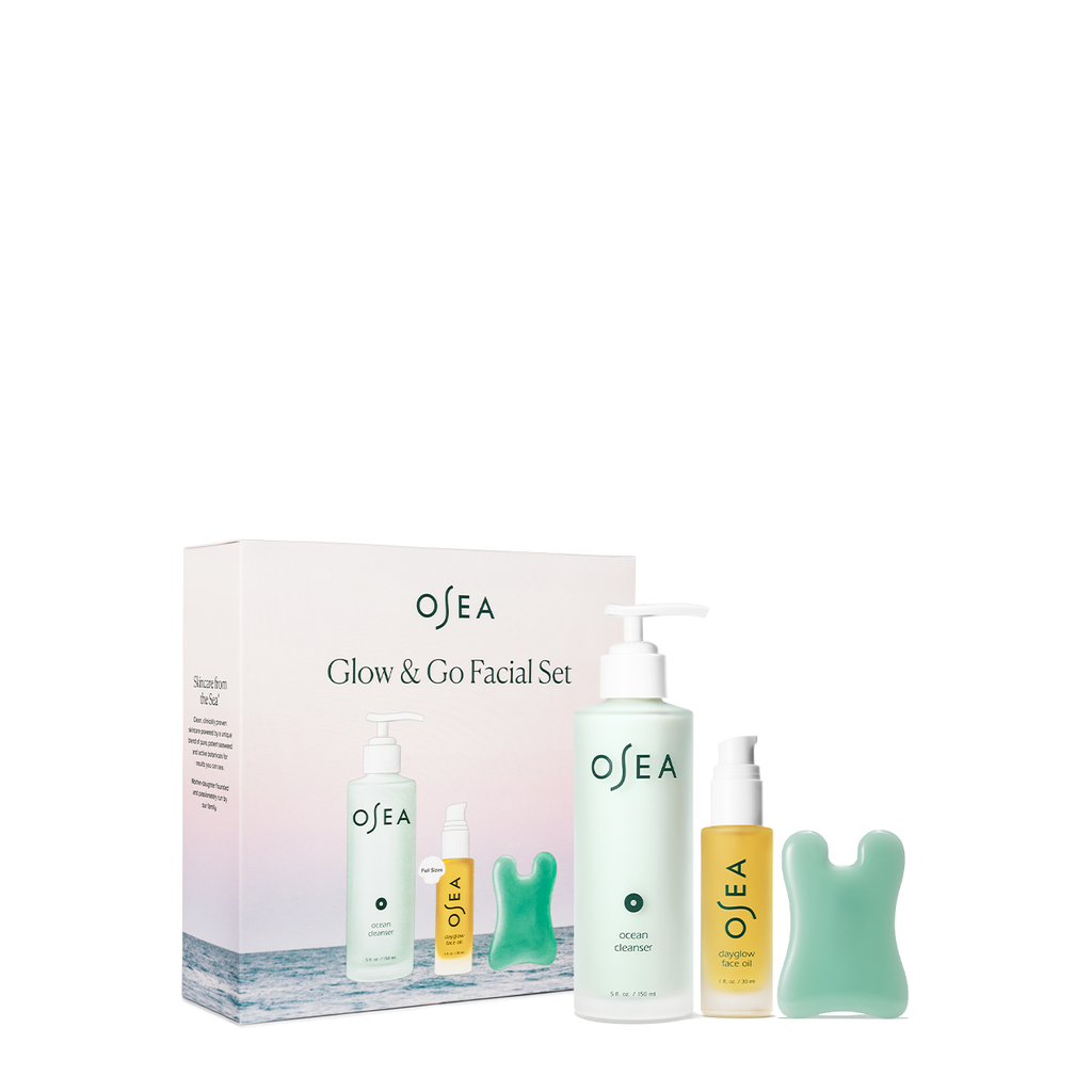 Skincare product set from osea featuring a facial cleanser, serum, and a gua sha tool.
