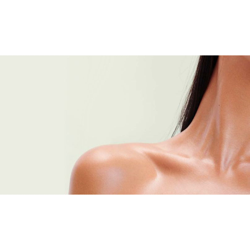 Close-up of a woman's neck and shoulder area with visible musculature.