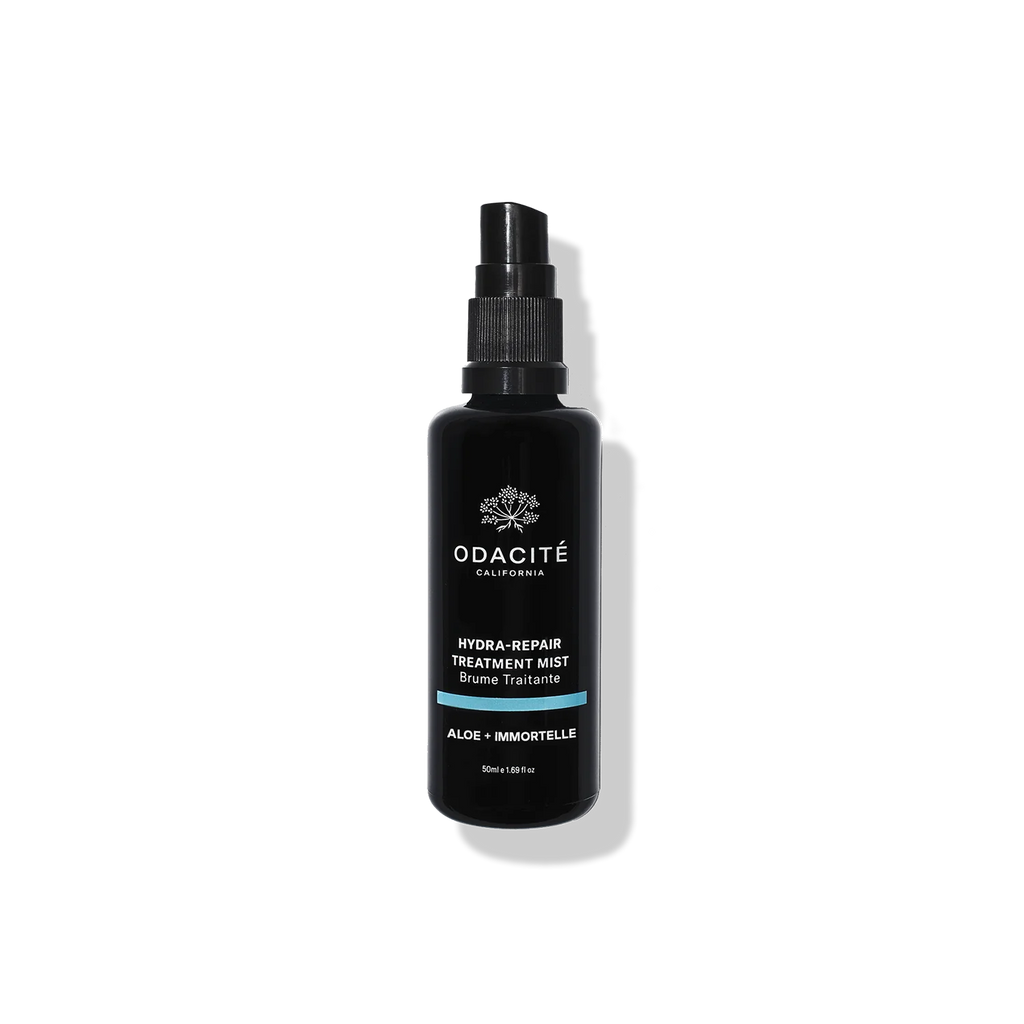 Black spray bottle of odacite hydra-repair treatment mist against a white background.