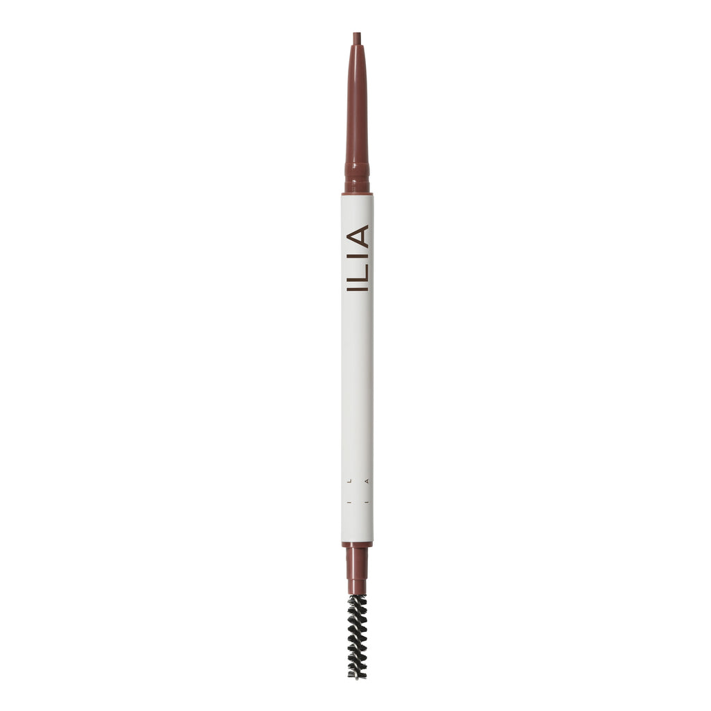 An ilia brand eyebrow pencil with a spoolie brush at one end.