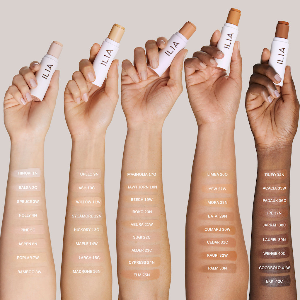 A range of diverse hands holding different shades of concealer, showcasing a variety of skin tone colors.