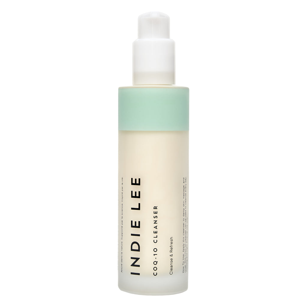 Bottle of Indie Lee COQ-10 Cleanser with a white label and a green gradient cap on a white background.