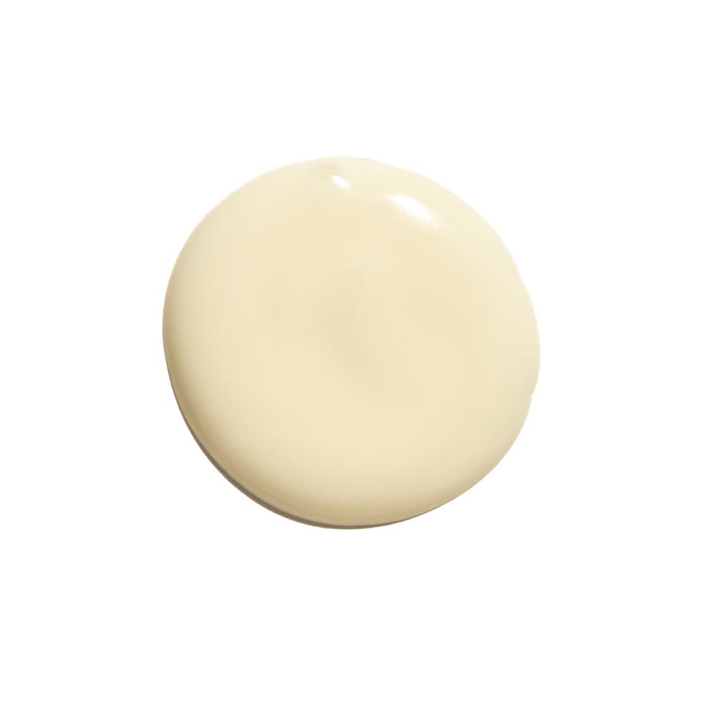 A dollop of thick, creamy white Indie Lee COQ-10 Cleanser on a plain white background.