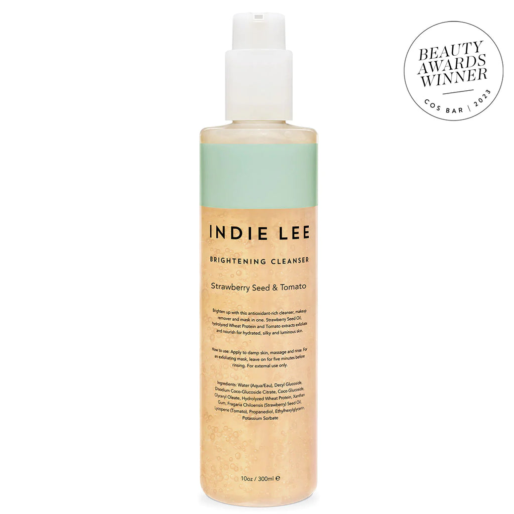 Bottle of indie lee brightening cleanser with strawberry seed and tomato, beauty award winner badge displayed.
