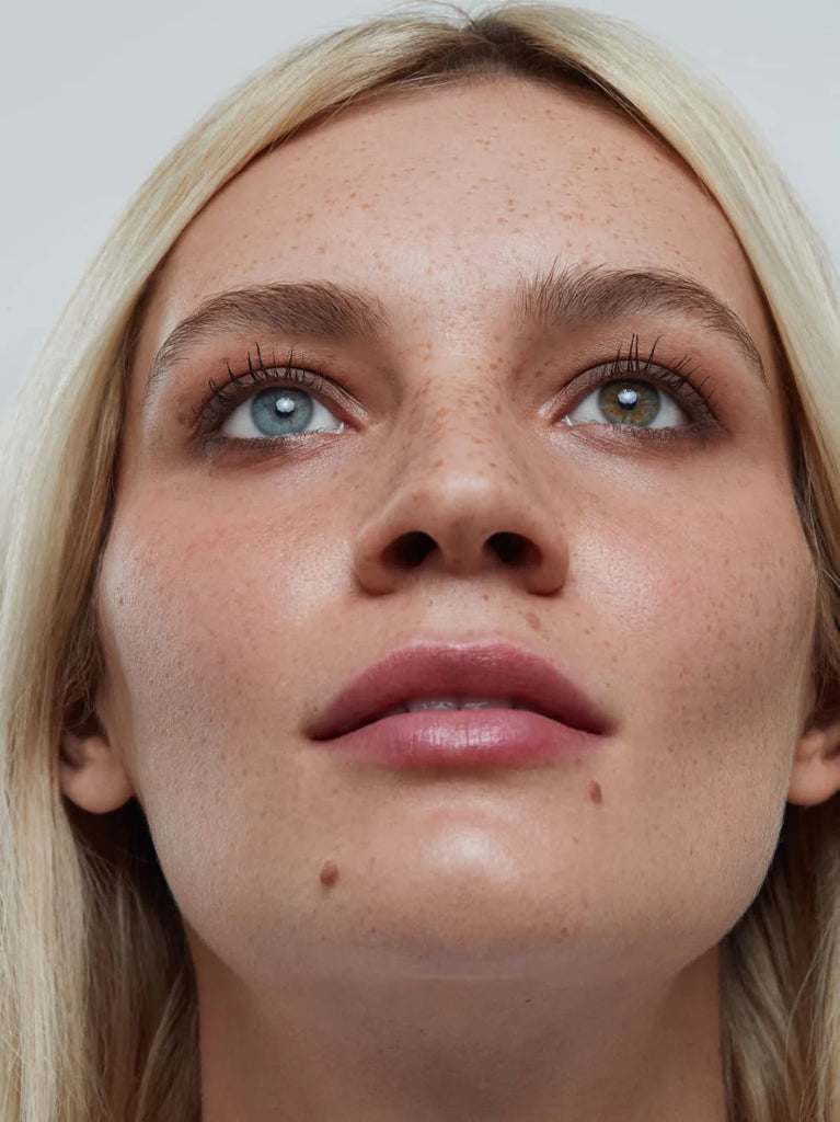 Model wearing BARK 01: Cool, rich brown with a silky matte texture, this neutral shade emphasizes every eye color. Applied around the lash line, it contours and makes lashes appear thicker.