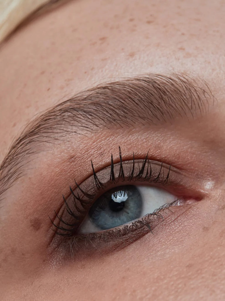 Model wearing BARK 01: Cool, rich brown with a silky matte texture, this neutral shade emphasizes every eye color. Applied around the lash line, it contours and makes lashes appear thicker.