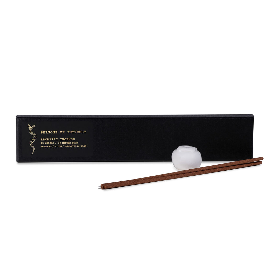Incense sticks with a ceramic holder packaged in a sleek black box labeled "persons of interest aromatic incense.
