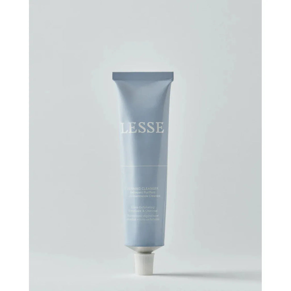 A tube of lesse refining cleanser on a plain background.