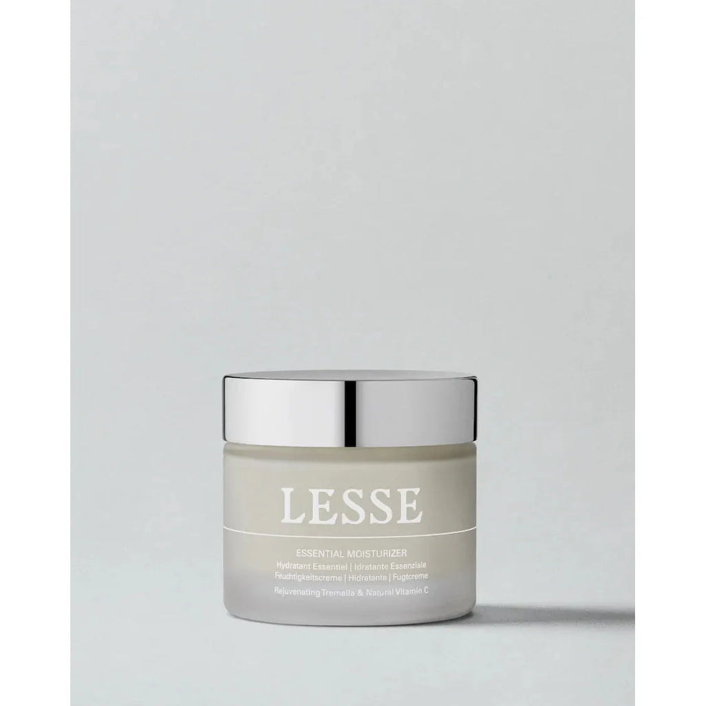 Jar of lesse essential moisturizer against a neutral background.
