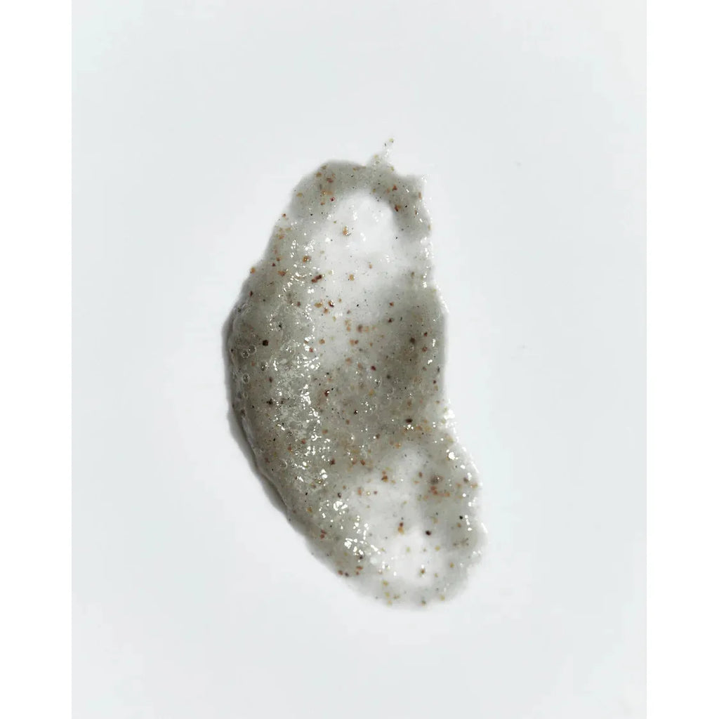 A dollop of exfoliating scrub on a white background.