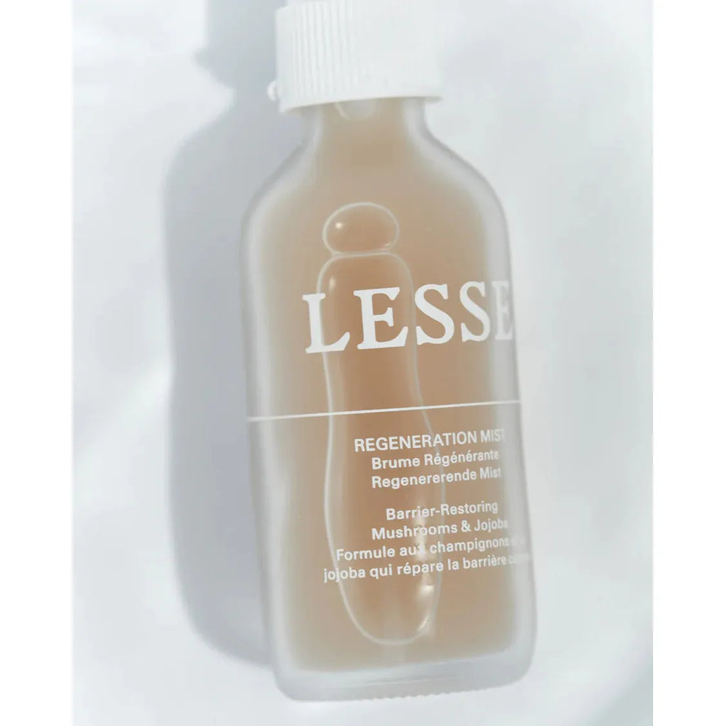 Translucent bottle of lesse regeneration mist skincare product with text detailing its barrier-restoring formula.