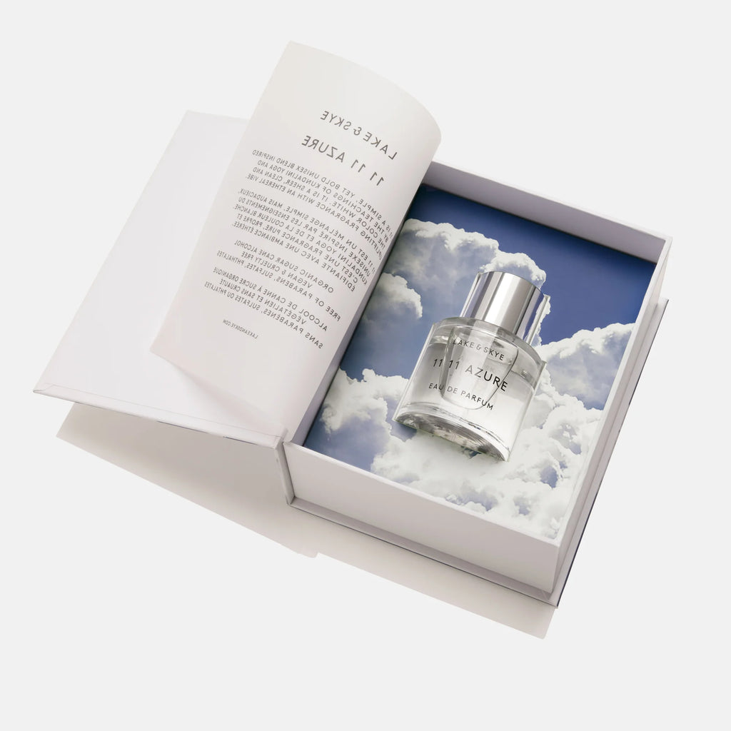 Bottle of perfume named "azure" placed in an elegant box with cloud design lining.