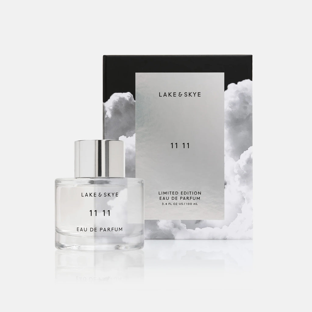 A bottle of lake & skye 11 11 eau de parfum in front of its packaging.