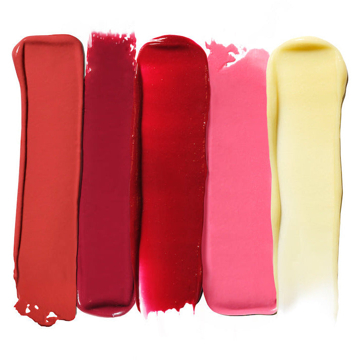 Five strokes of lipstick in different shades ranging from nude to red.