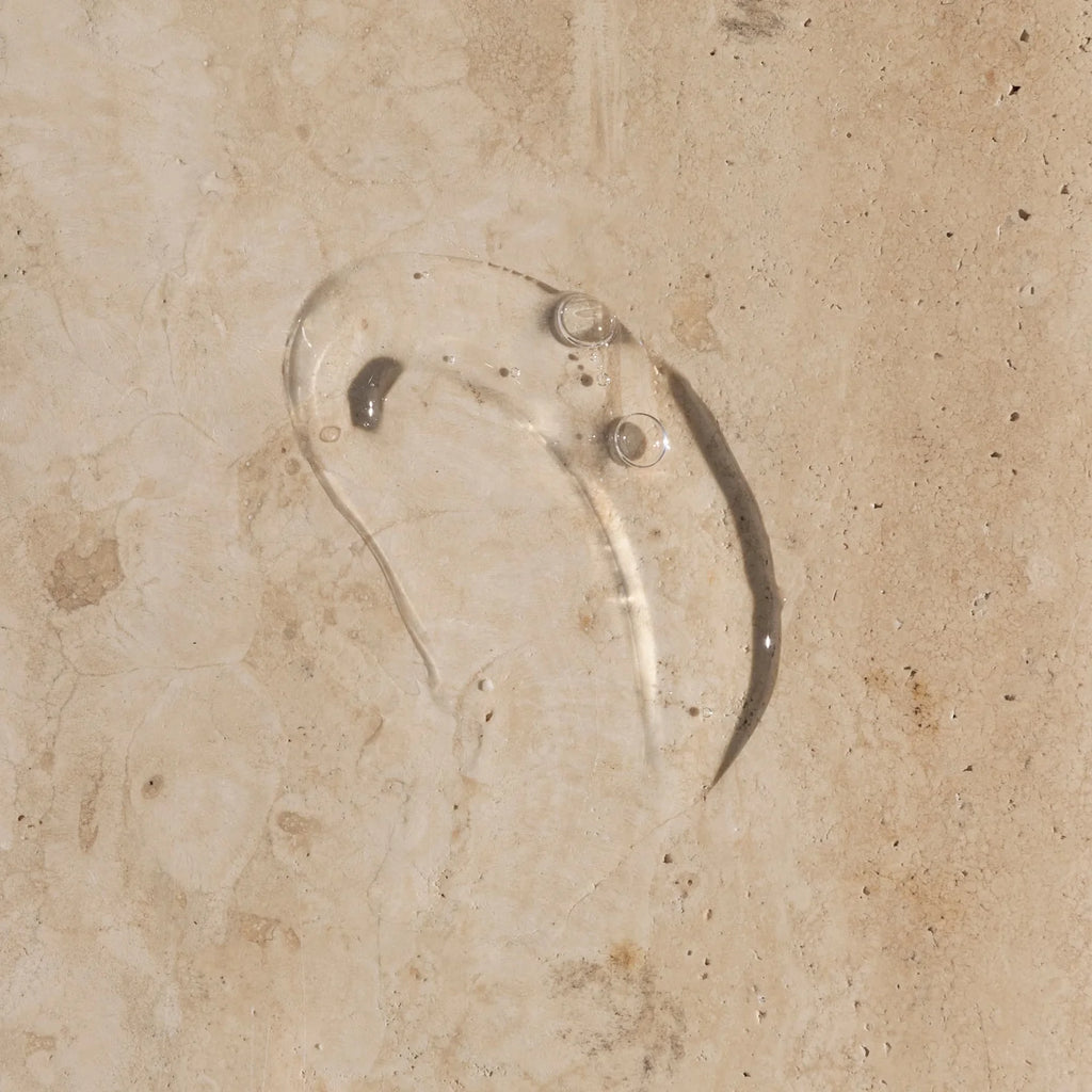 A wet footprint on a concrete surface.