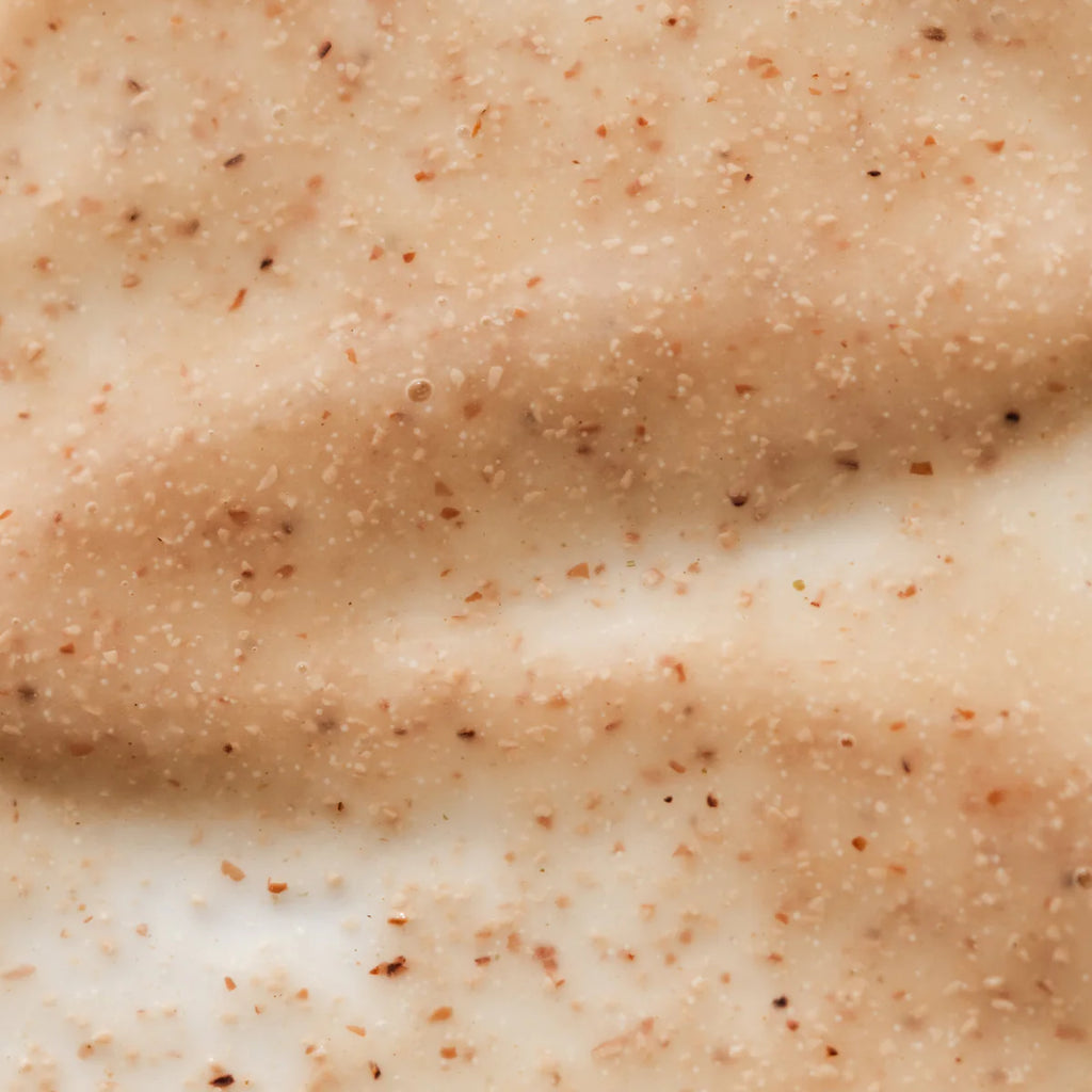 Close-up texture of a scrub or exfoliating cream with small particles.