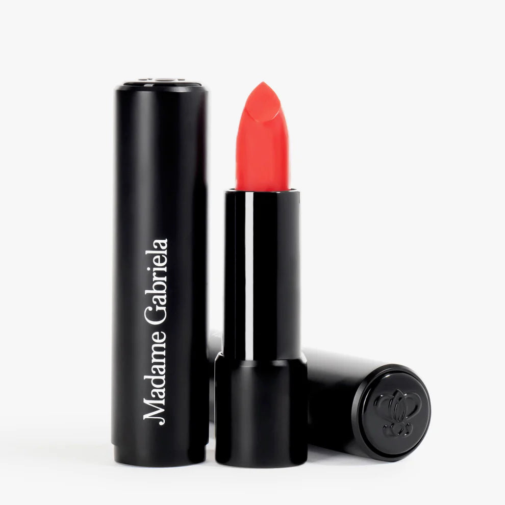 Red lipstick with black casing on a white background.
